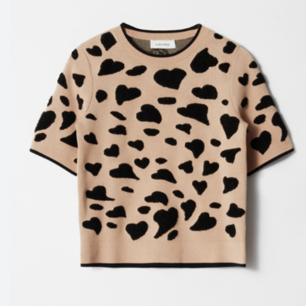 Short-sleeve knitted jacquard top featuring a ribbed neckline, cuffs and hem.  •